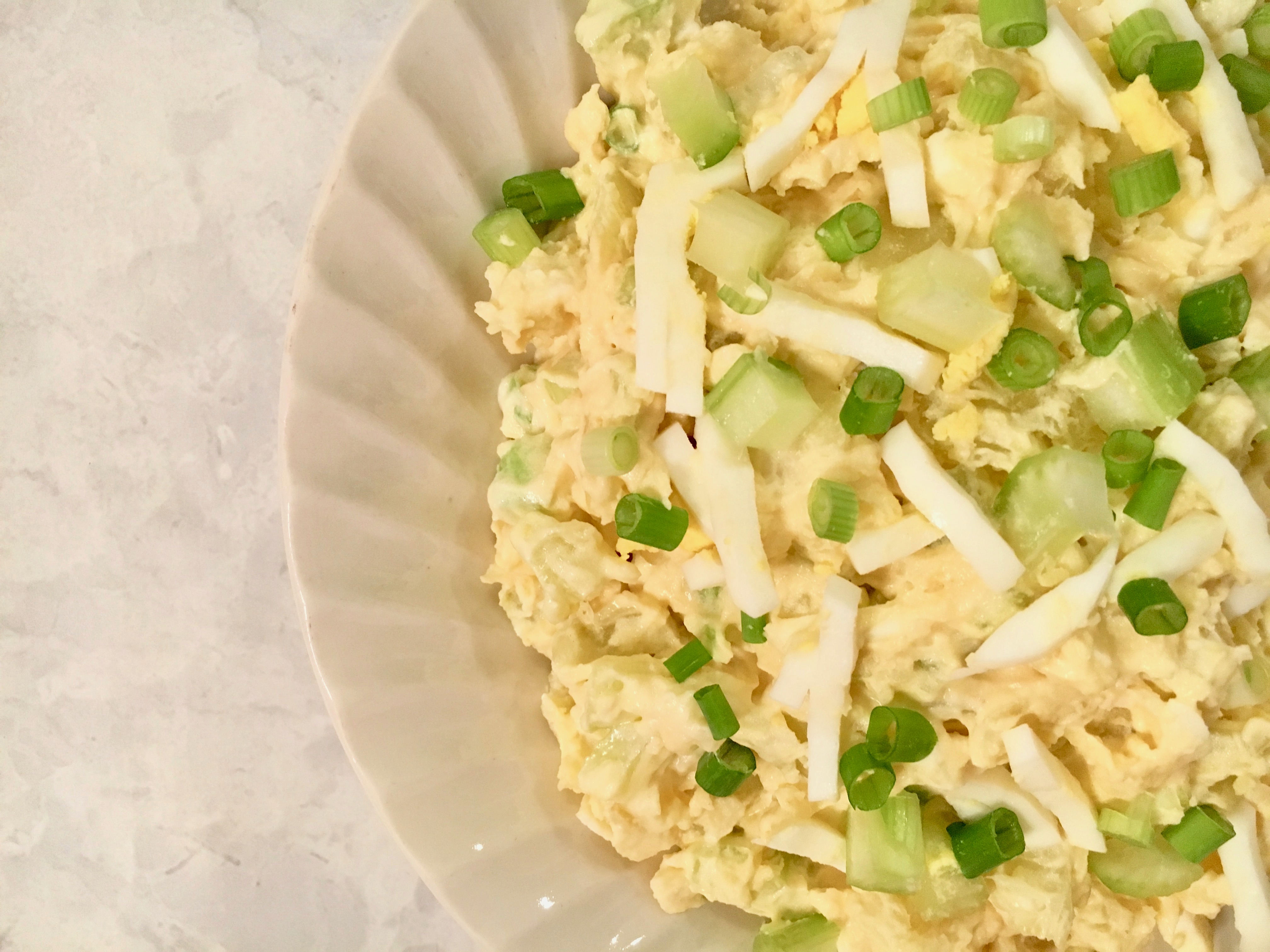 This Easy No Mayo Potato Salad Recipe is will become a favorite at your next picnic, BBQ or potluck. This potato salad is elevated by the spicy addition of Dijon mustard. Sour cream replaces the mayonnaise and the addition of egg, celery, green onions and dill pickle make this a zesty potato salad worthy of your next gathering.