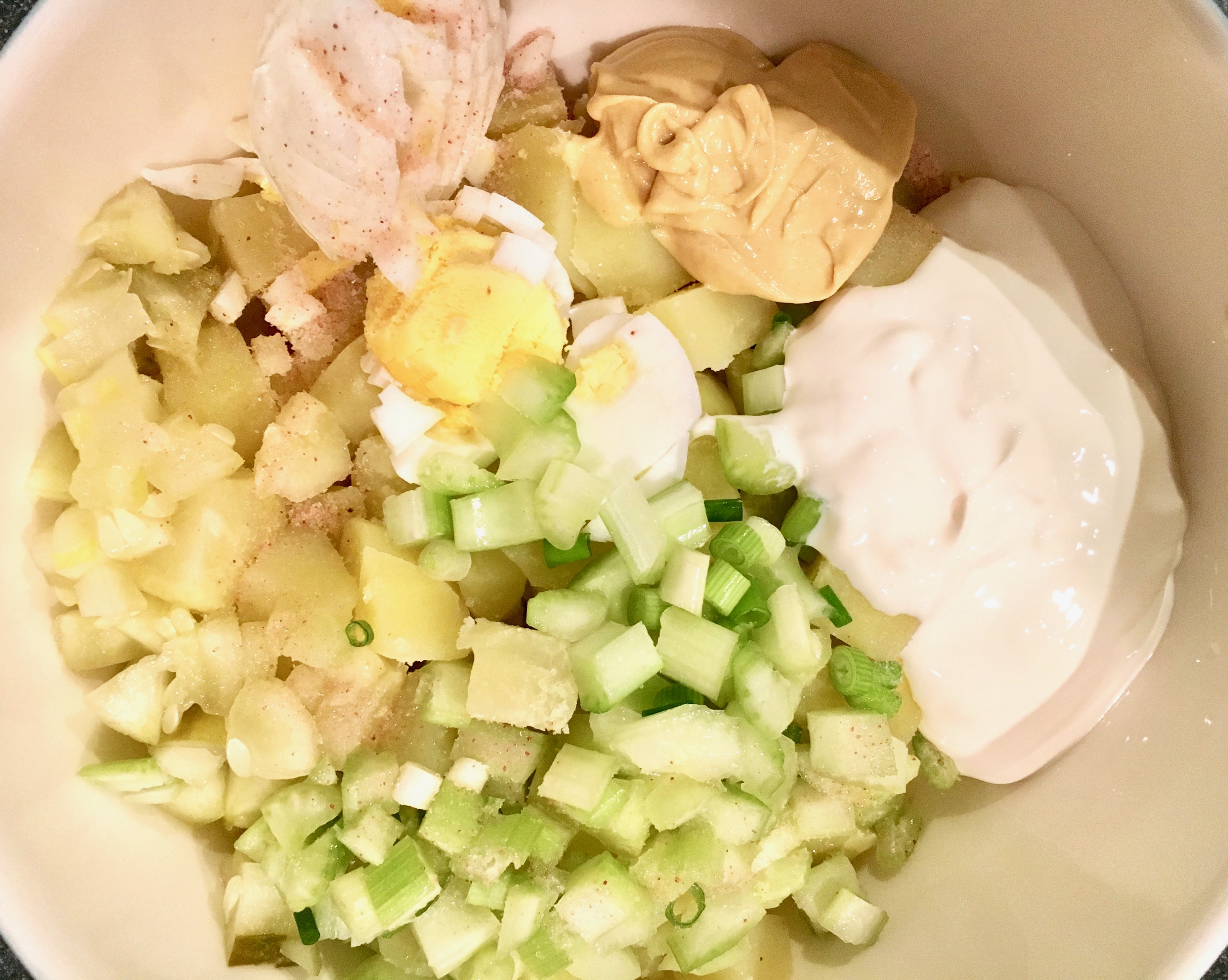 This Easy No Mayo Potato Salad Recipe is will become a favorite at your next picnic, BBQ or potluck. This potato salad is elevated by the spicy addition of Dijon mustard. Sour cream replaces the mayonnaise and the addition of egg, celery, green onions and dill pickle make this a zesty potato salad worthy of your next gathering.