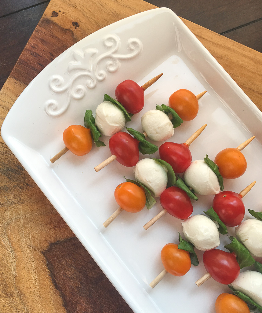 This quick and easy appetizer is sure to be a hit at your next party. Traditional elements of a Caprese salad, tomato, basil and mozzarella are arranged on a short skewer for an instant and savory appetizer.